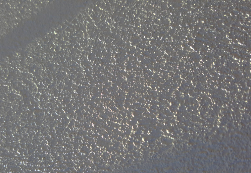 Close-up of textured rendered masonry prepared for property signwriting in Kensington.