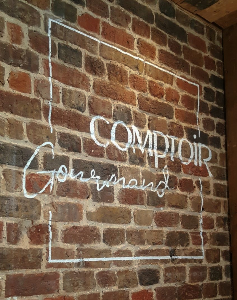 Completed white brick wall signwriting for Comptoir Gourmand in Soho, London.