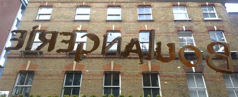23ct gold leaf being applied to reverse-painted glass signwriting for Comptoir Gourmand in Soho.