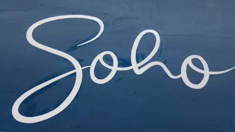 Completed Soho script lettering painted onto the masonry fascia for Comptoir Gourmand in London.