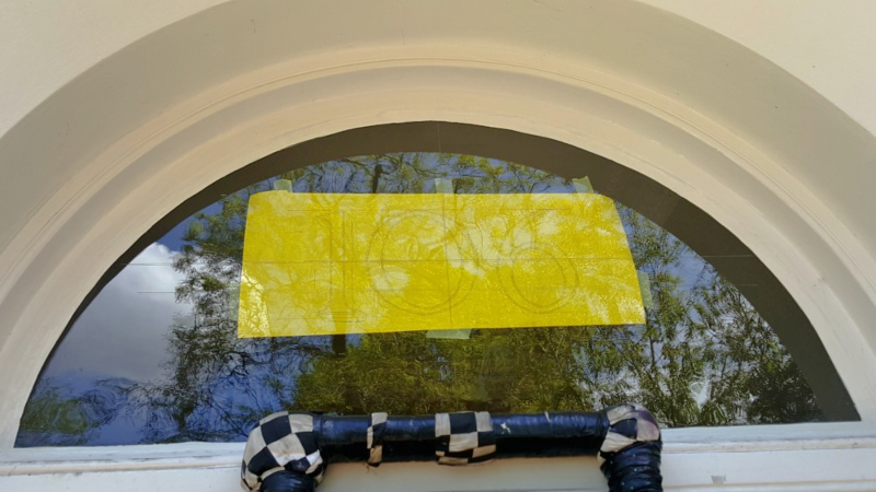 Artwork template positioned behind the fanlight glass ready for reverse painting.