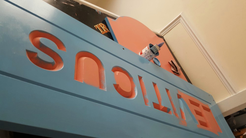 Brush application of primer and undercoat during preparation of a carved Accoya wooden sign