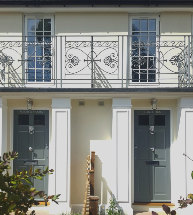 Adjacent entrances of Chase House and Fairview House showing matching hand painted house names in Enfield.