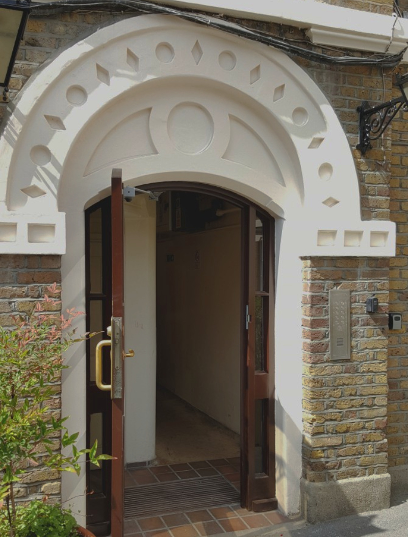 Entrance arch prepared and repainted before hand painted entrance numbering was applied.
