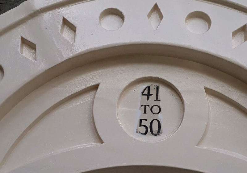 Original entrance numbering before being repainted during refurbishment works.