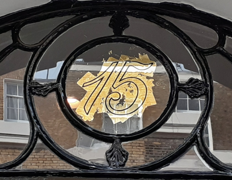 Applying genuine 23ct gold leaf to the reverse of the decorative fanlight roundel using traditional water gilding techniques.