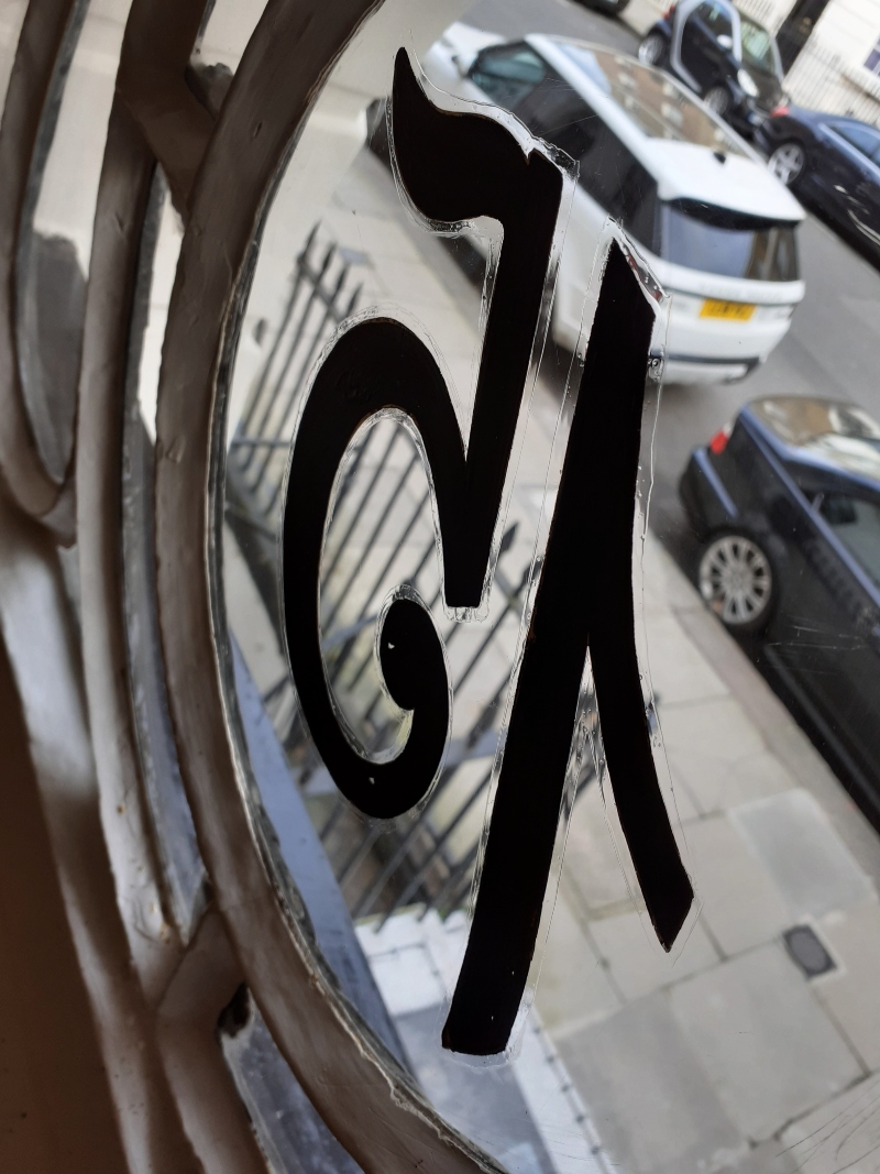 Completed 23ct gold leaf property numbering within the decorative circular fanlight roundel of a Regency townhouse near Hyde Park.