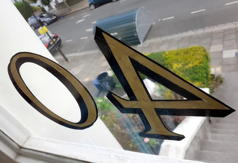Applied genuine 23ct gold leaf to reverse glass fanlight numbering using traditional oil gilding techniques.