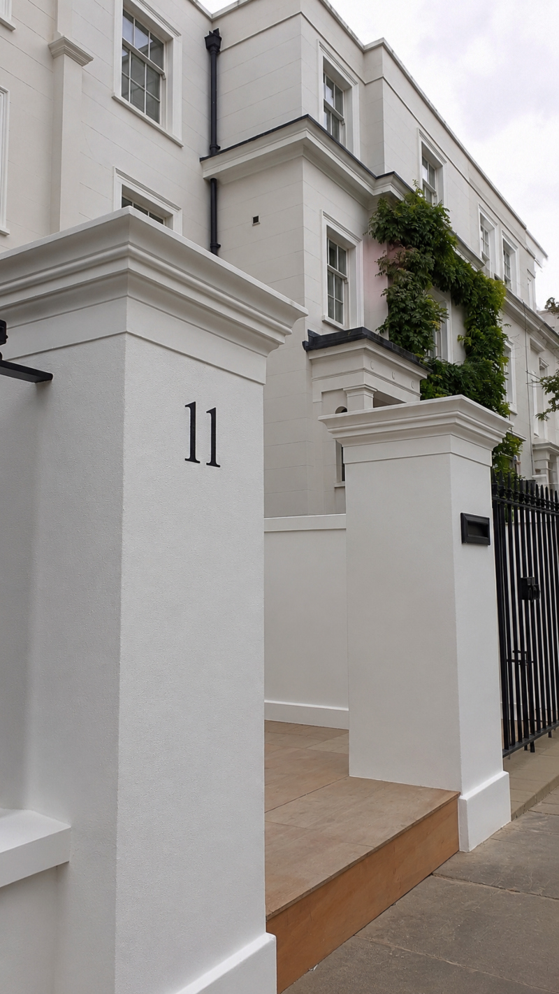 Architectural house numbering hand painted onto a rendered entrance pier at a distinguished private residence on Albert Place, Kensington W8.