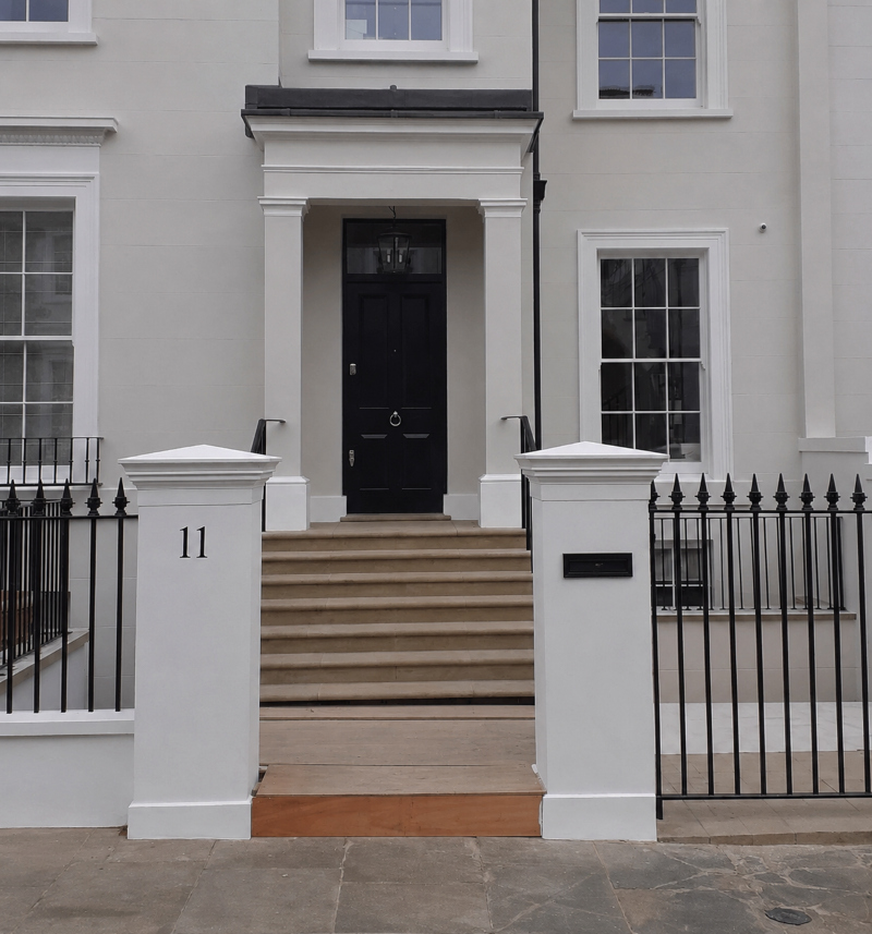 Hand painted house number on a rendered entrance pier providing elegant property identification for a private residence in Kensington W8.
