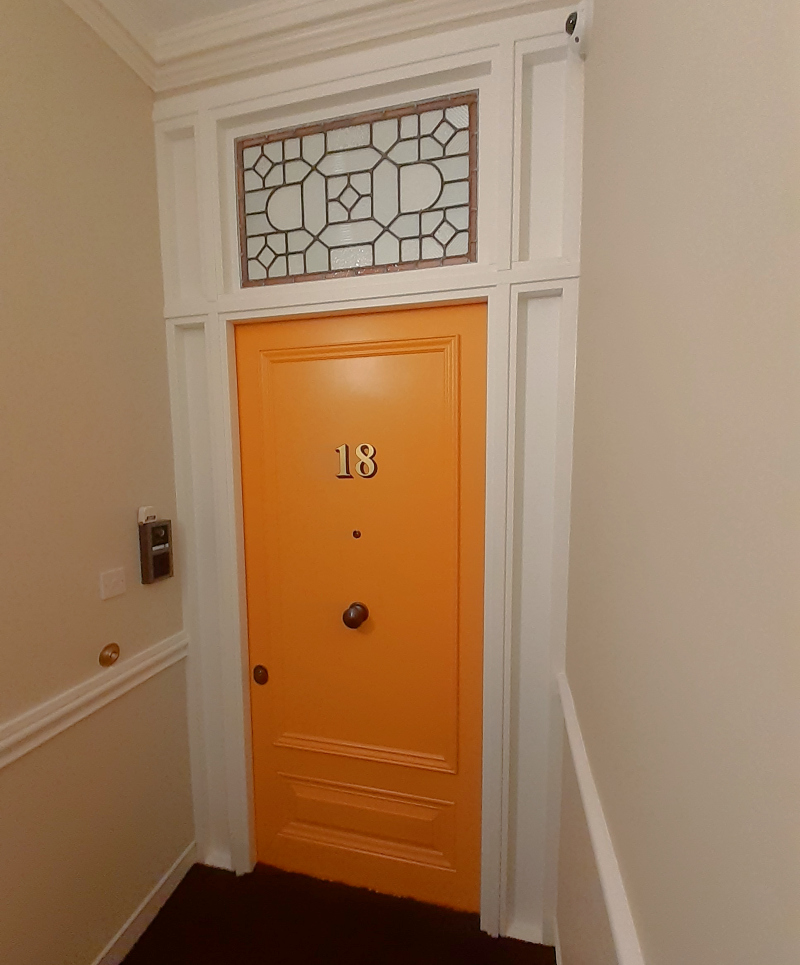 Architectural gold leaf door numbering completed on the principal entrance of a Victorian apartment in Bayswater.