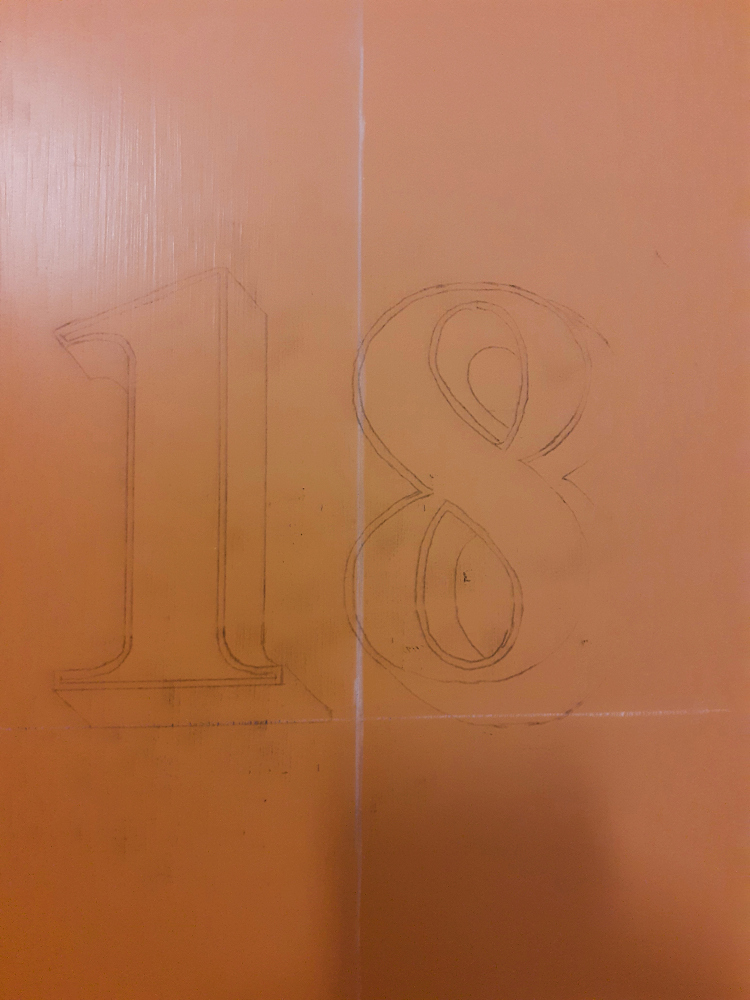 Traditional pounce pattern prepared for architectural gold leaf door numbering on a timber apartment entrance door.