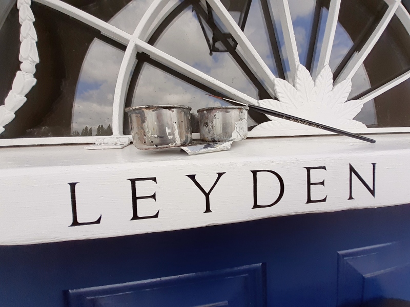 Fine Roman serif entrance signwriting painted by hand