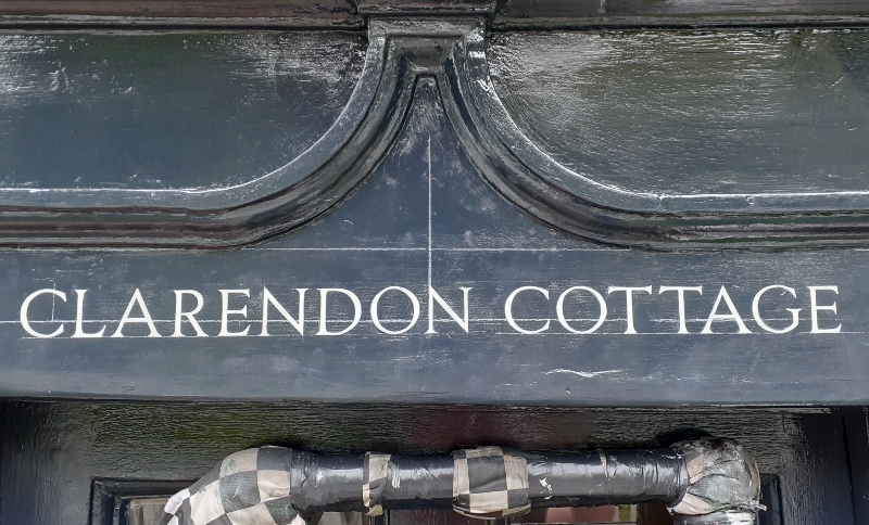 Fine Roman serif house name lettering painted by hand