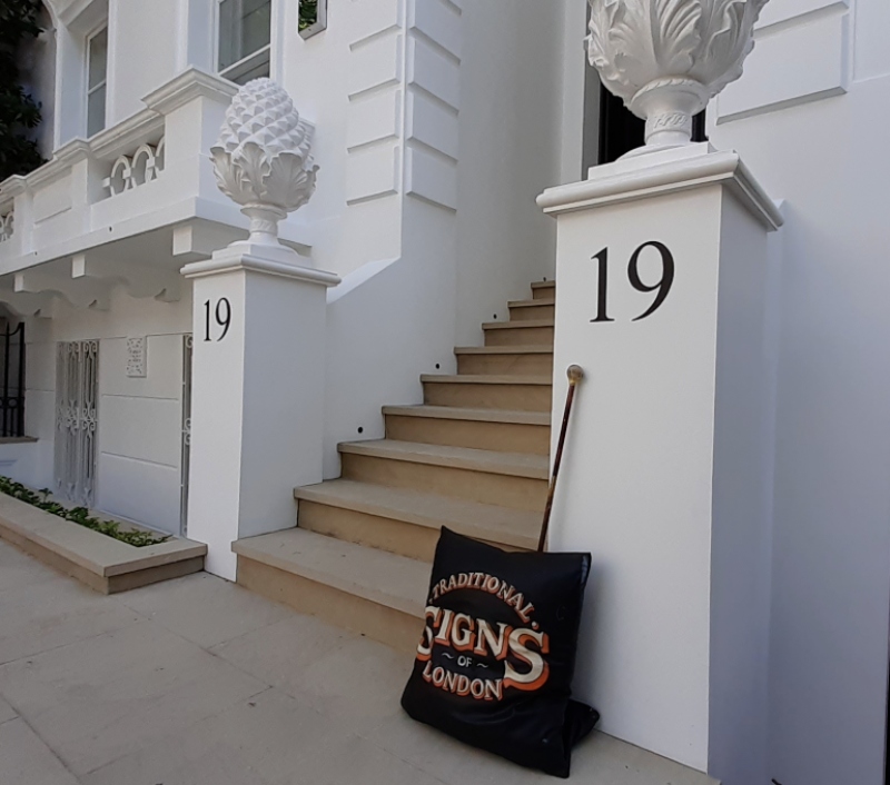 Architectural entrance numbering beneath pineapple finials