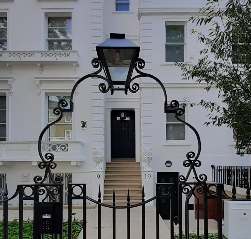 Architectural entrance numbering on rendered gate piers