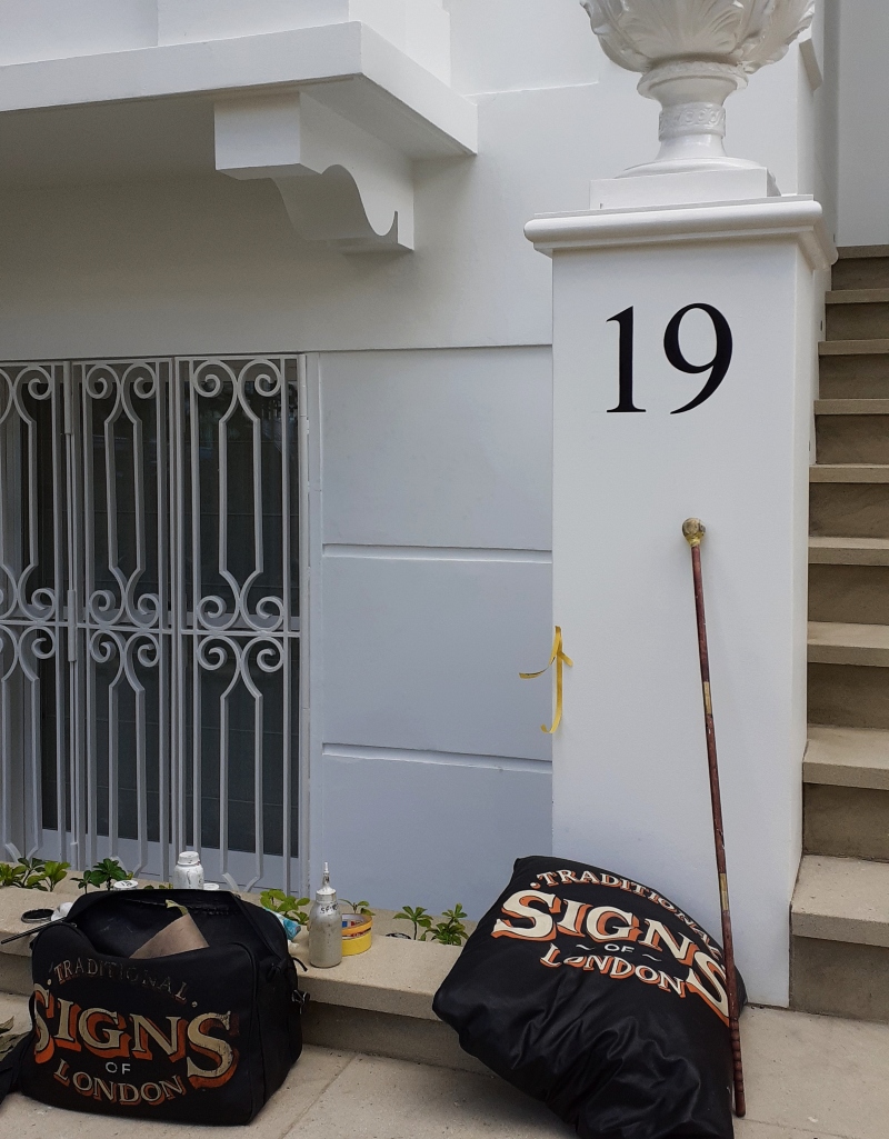 Traditional exterior numbering on London villa entrance