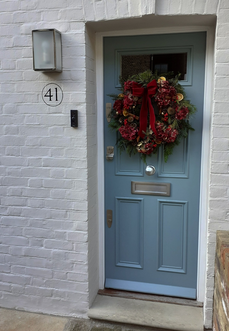 Exterior house numbering painted onto brickwork