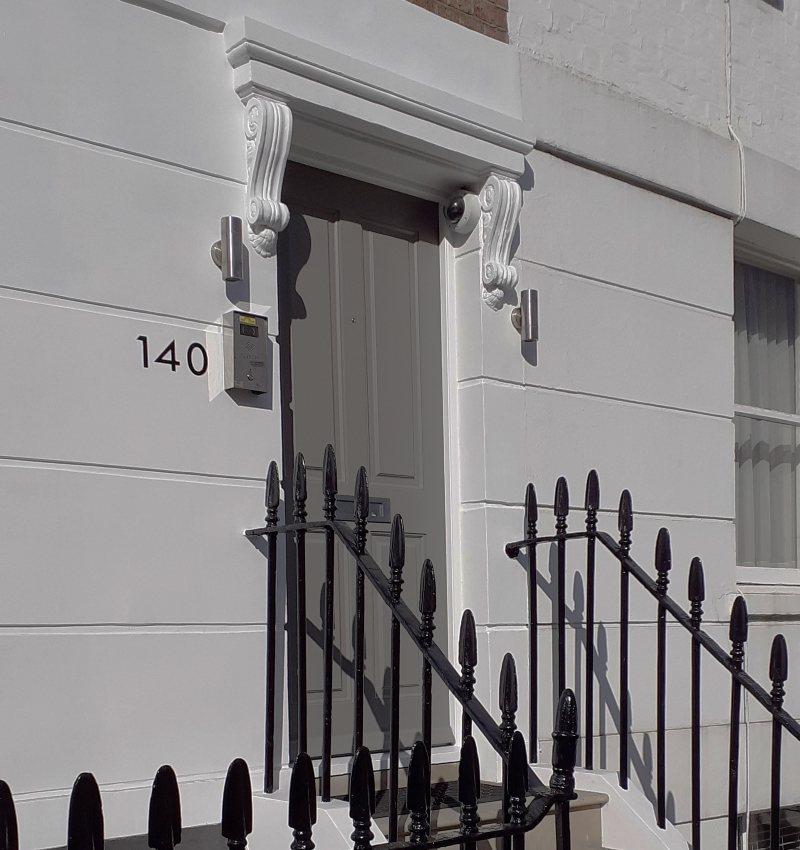 Exterior property numbering on stucco façade in London