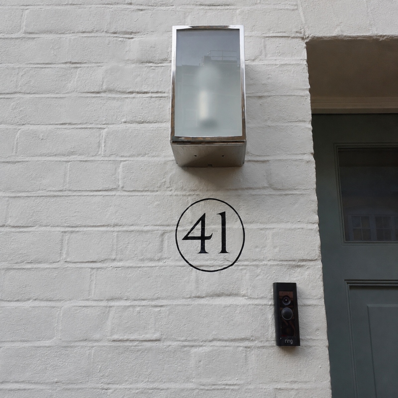 Hand painted number roundel on London property entrance