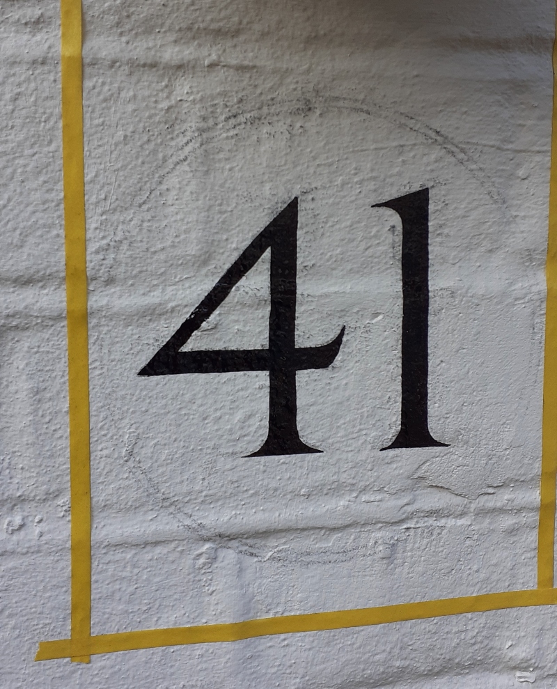 Traditional residential signwriting on painted brickwork