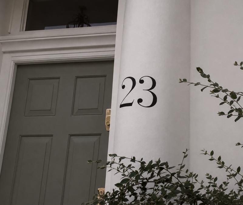 Architectural entrance numbering on masonry pillar