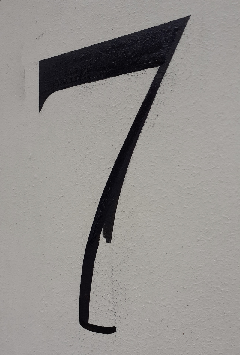 Hand painted exterior property numbering on masonry entrance