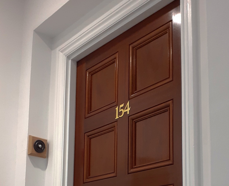 Hand painted gold leaf numbering on hardwood apartment door