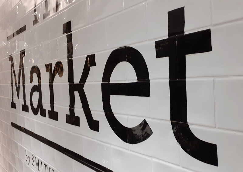 Hand painted interior signwriting on polished glazed tiles