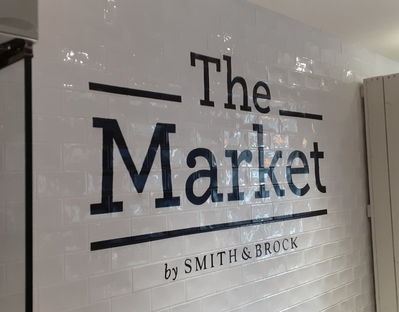 Hand painted tile lettering on glazed wall tiles in West London