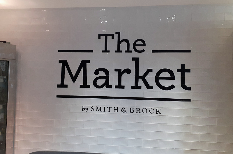 Restaurant interior signwriting painted on tiled wall