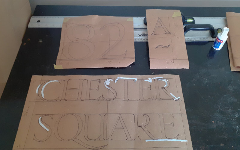 Traditional house number and street lettering on London property