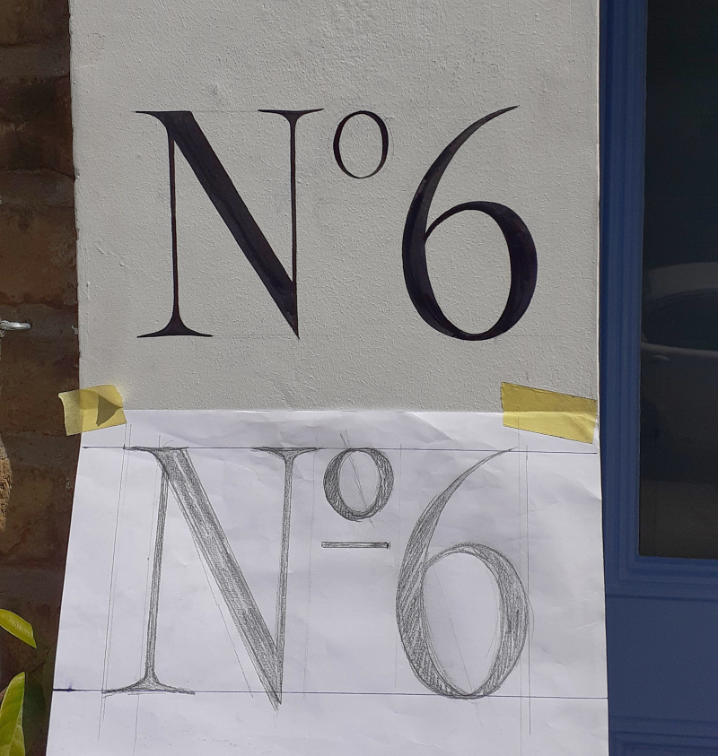 Traditional hand painted entrance numbering on London residence