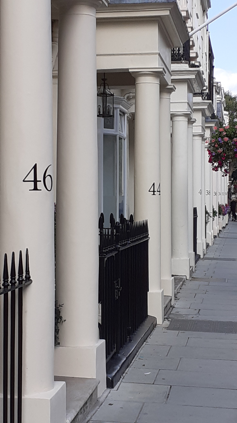 Architectural house numbers painted on portico entrance pillars