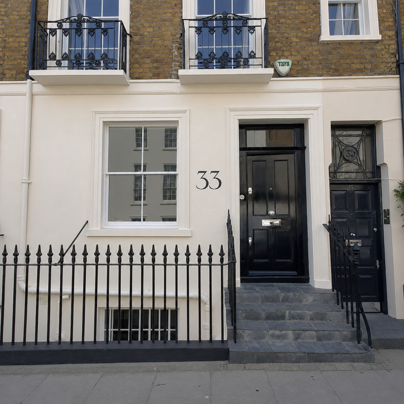 Architectural property numbering painted onto masonry façade