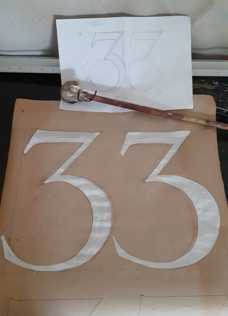 Roman serif house numbers painted by hand on London property