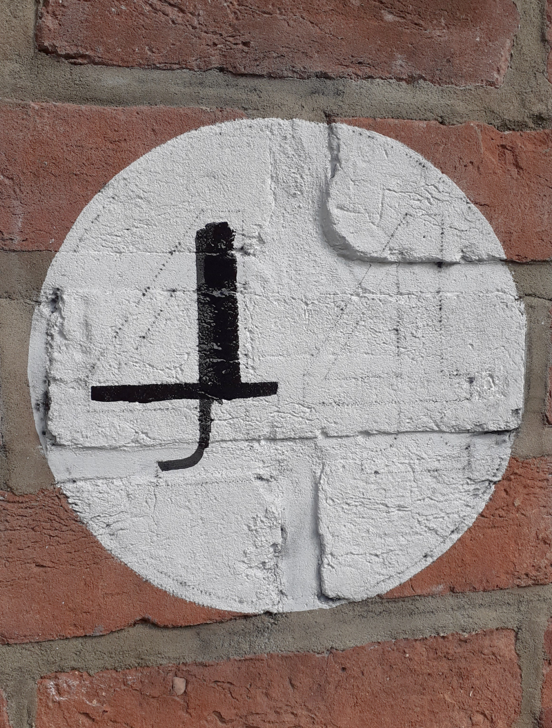 Painted house numbers on brick gate piers in Ealing London