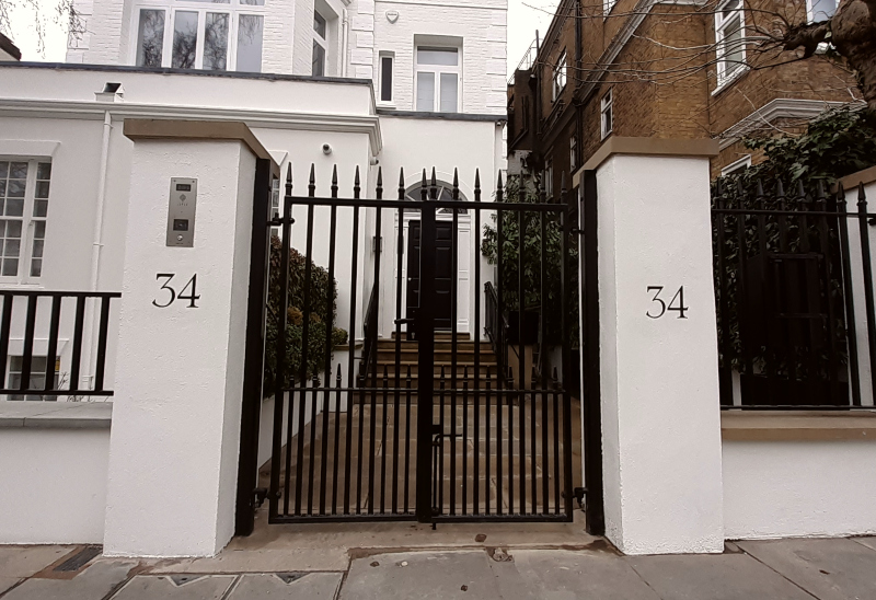 Hand painted house numbers on gate piers in Kensington London