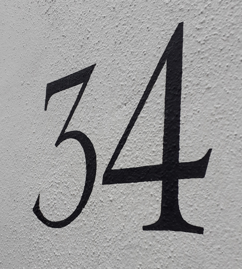 Traditional property signwriting on masonry gate piers in Kensington
