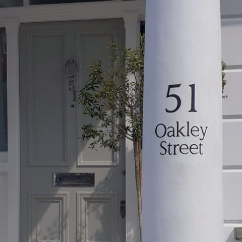 Hand painted house numbers on residential property in Chelsea London