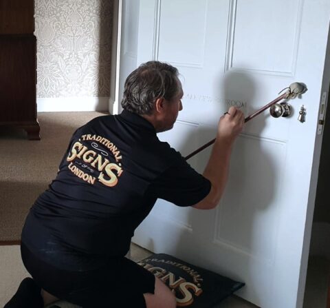 Hand-painted traditional signage London inside a prestigious residential property