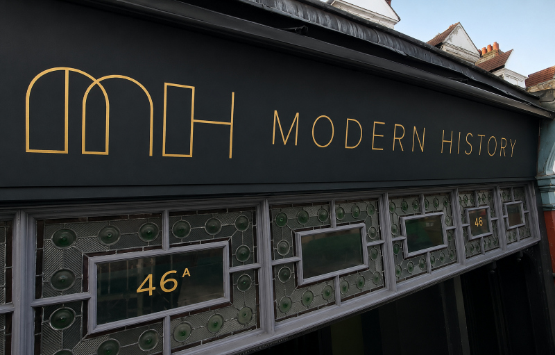 Close-up detail of gold leaf lettering on London shopfront